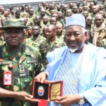 The Commandant, Armed Forces Command and Staff College (AFCSC), presenting a plaque to the Minister of Defence, Muhammad Badaru on Tuesday in Kaduna